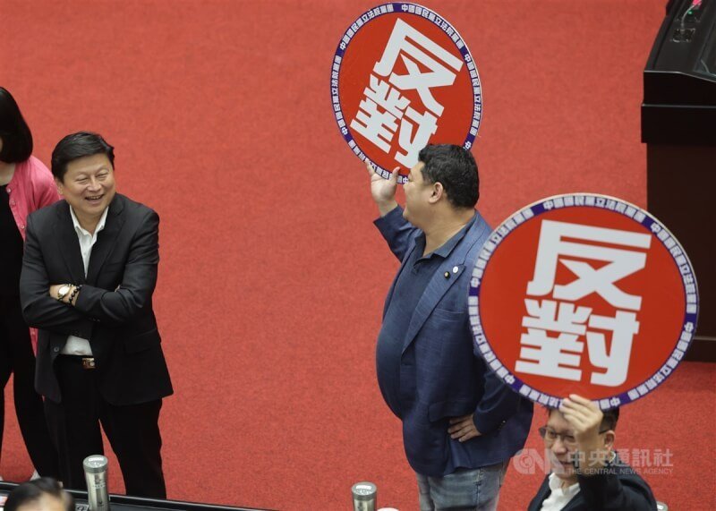 國民黨立委游顥（右2）、馬文君等提出為救國團解套的政黨及其附隨組織不當取得財產處理條例修正草案，14日經由表決付委審查。國民黨團下達甲級動員，國民黨立法院黨團總召傅崐萁（左）與黨籍立委出席表決，手舉「反對」標語提醒按鈴。中央社記者裴禛攝 113年6月14日